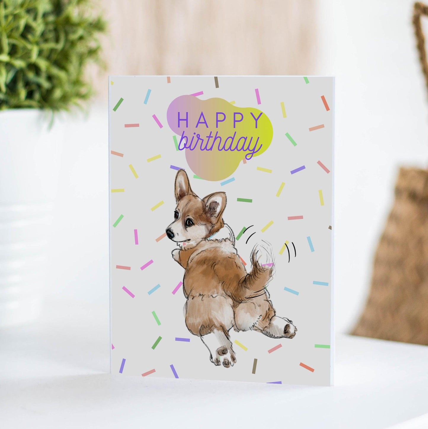 corgi dog with wagging tail in confetti birthday card