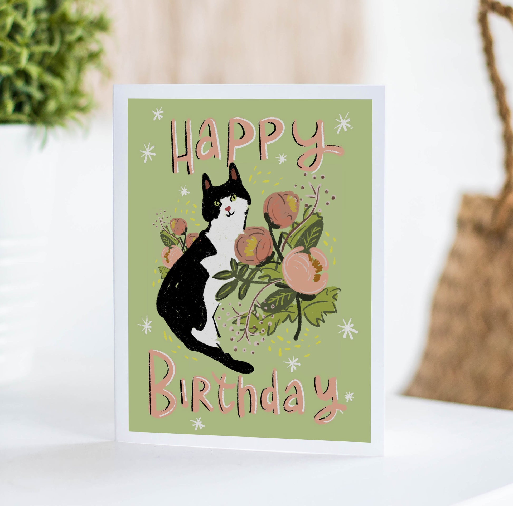 green birthday card with black and white cat and peach floral illustration